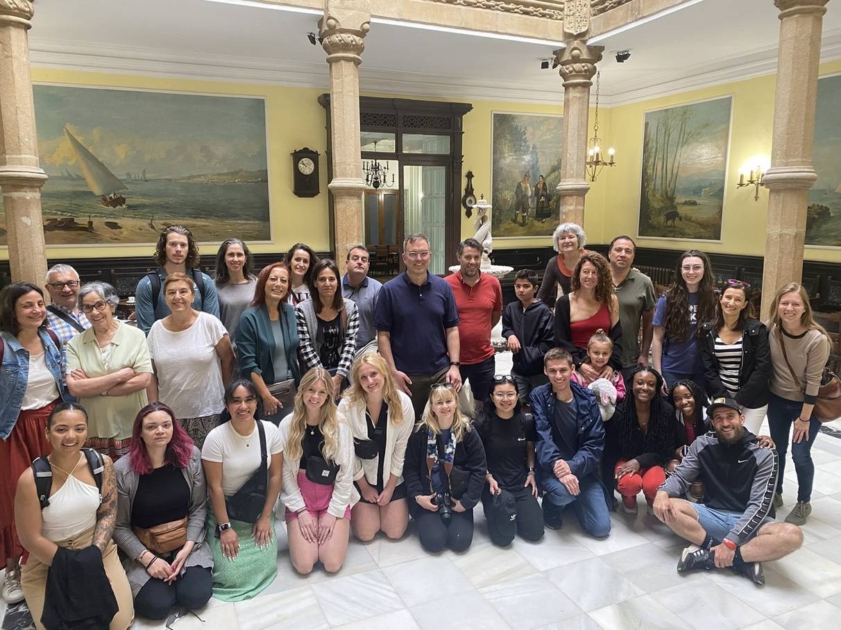 A group of students and faculty posing in Spain for a group photo